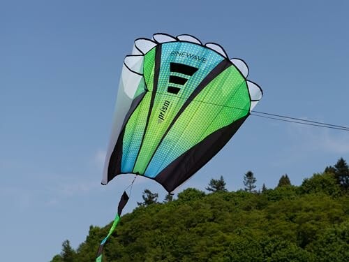Green and blue parachute kite flying in the sky